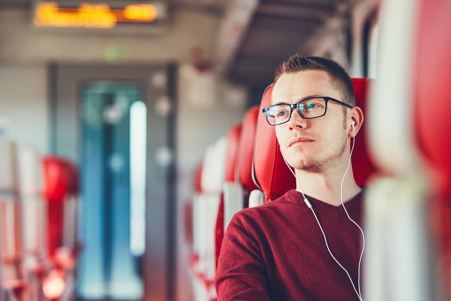 Young man traveling by train implementing tips for protecting your identity while traveling