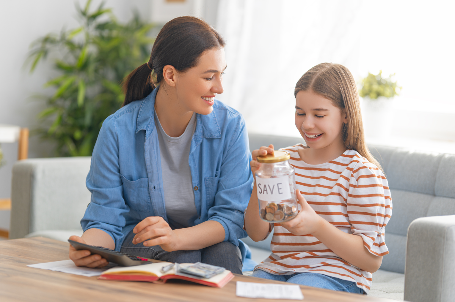 woman helping in building up your child's credit and teaching teenage girl how to calculate family budget