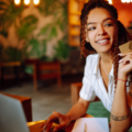 Young woman sitting at cafe How to Lower Your Credit Card Interest Rate making online shopping, using credit card and laptop. Online shopping