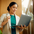 Young Asian businesswoman reading an e-mail on what is the equal ctedit opportunity act on laptop in the office.